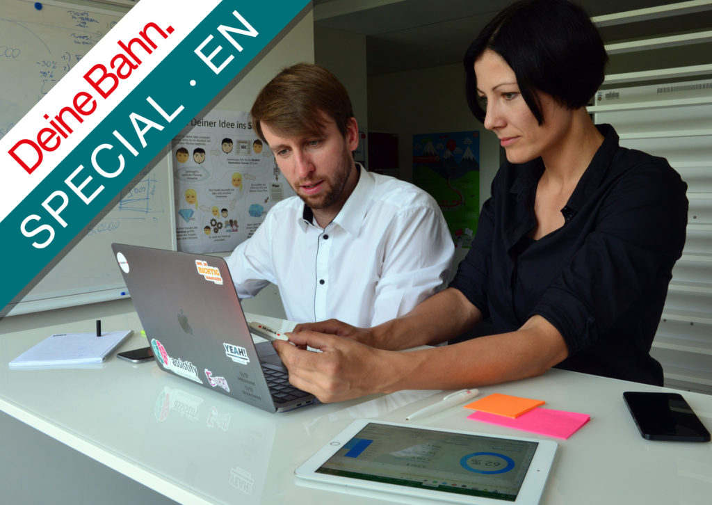 man and woman in office in front of laptop